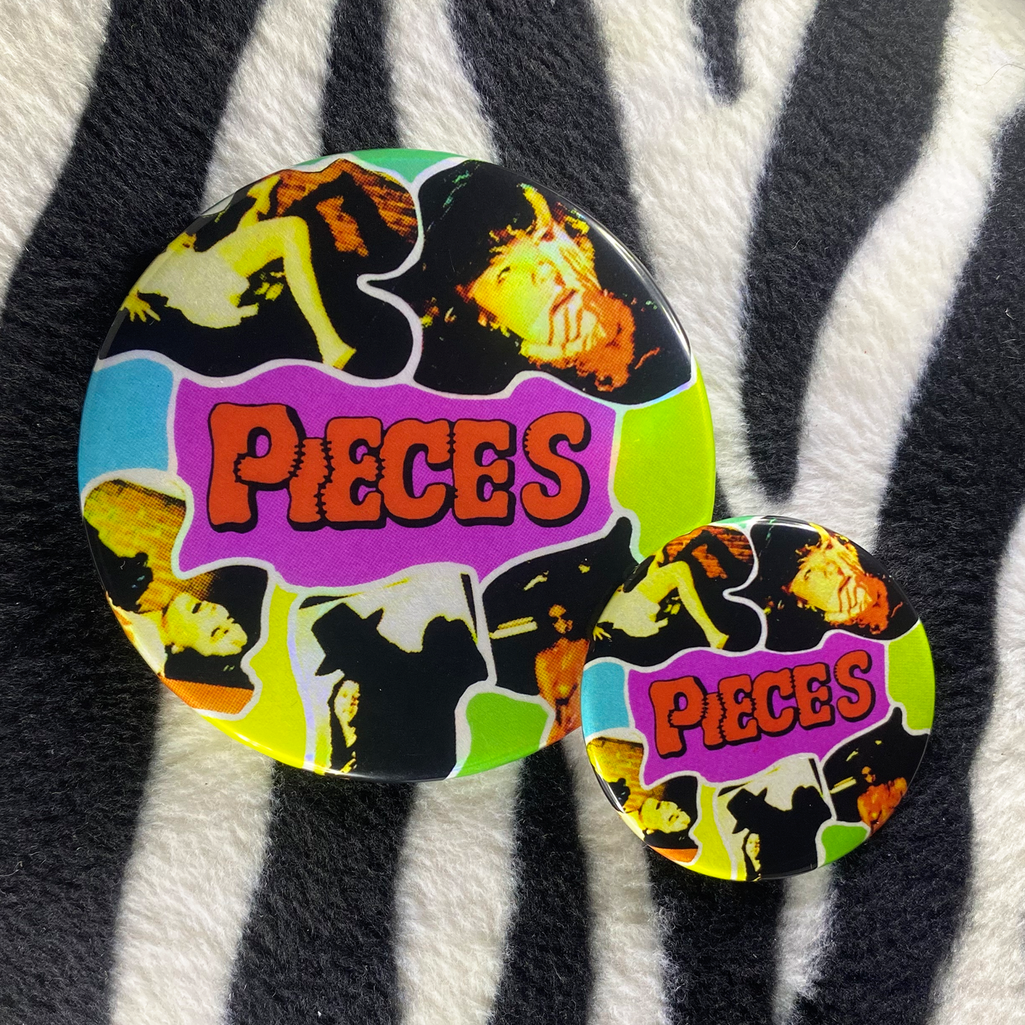 "PIECES" pinback button